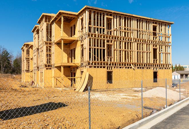 a close-up of temporary chain link fences enclosing a construction site, signaling progress in the project's development in Ardsley NY